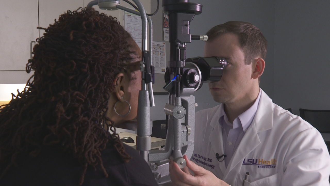 Dr. Brinkley examines eyes.jpg